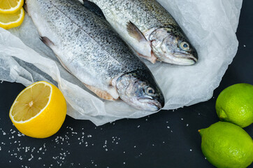 Raw peeled whole trout on black background