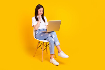 Fototapeta na wymiar Full length profile side photo of young woman happy smile sit chair look laptop think report isolated over yellow color background