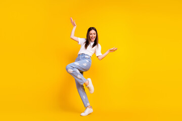 Full size photo of young excited girl happy positive smile have fun dance party isolated over yellow color background
