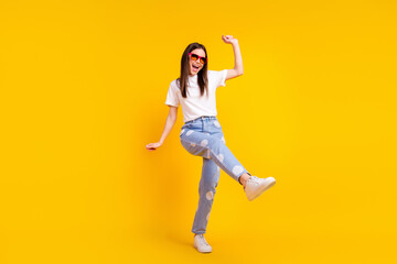 Fototapeta na wymiar Full size photo of young excited girl happy positive smile have fun enjoy party dance isolated over yellow color background