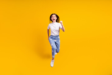 Fototapeta na wymiar Full body photo of young girl happy positive smile jump up go walk run hurry isolated over yellow color background