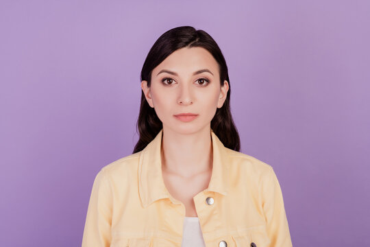 Portrait of focused manager girl calm look camera on purple background