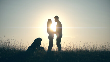 The couple of travelers standing on the blue sky background