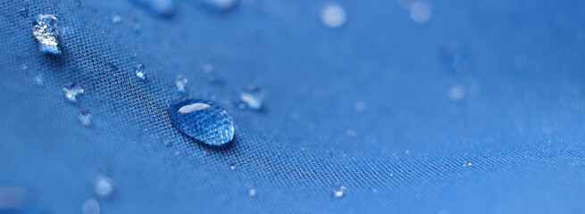Water Proof Textile block water to pass through to stay dry. water beading on fabric. soft focus,...