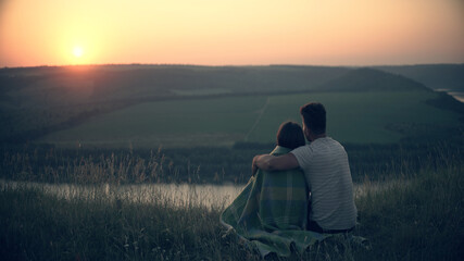Fototapeta na wymiar The man and woman admiring the beautiful sunset view