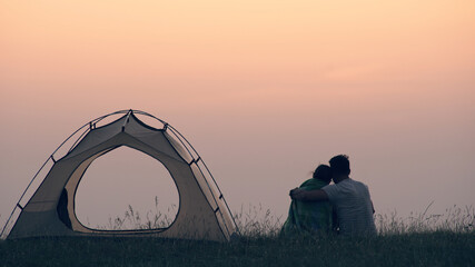 The man caring about his woman at the campsite