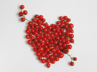 Heart shaped cherry tomatoes on white background.