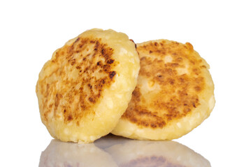 Two flavored homemade cottage cheese pancakes, close-up, isolated on white.