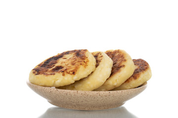 Several fragrant homemade cheesecakes with ceramic dishes, close-up, isolated on white.