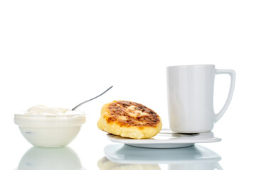 Several fragrant homemade cheesecakes with ceramic dishes, close-up, isolated on white.