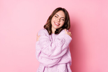 Photo of charming inspired lady embrace shoulders wear knitted sweater isolated pink color background