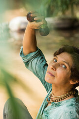 woman in nature holding mangosteen in her hands, vegetarian concept