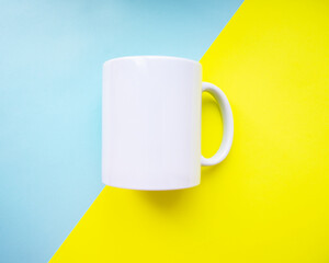 White mug clear empty for design on blue yellow background