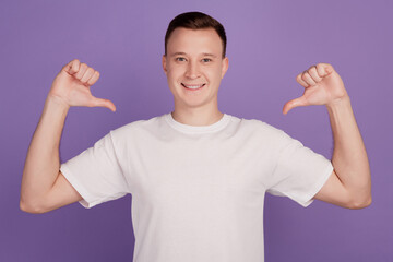 Portrait of egocentric narcissistic guy direct thumbs himself on violet background