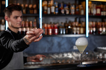 barman is making cocktail with smoky air bubble
