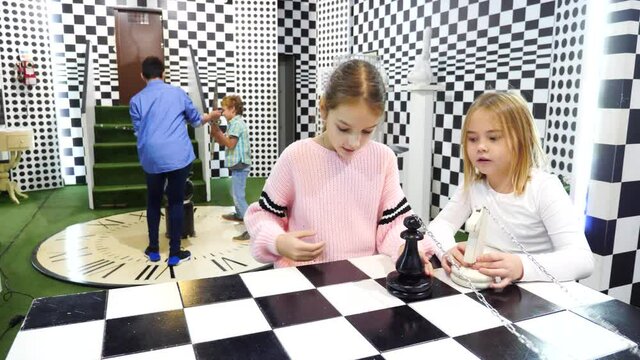 Enthusiastic children play in the chess quest room