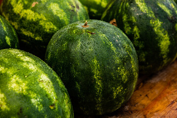 fresh watermelon with dew on wooden table