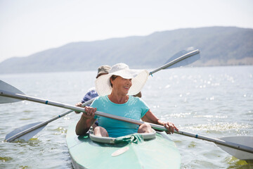 Senior couple enjoying kayaking on the river.  Social Distancing. Digital detox. Staycations,...