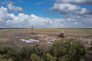 Drilling rig in oil field for drilled into subsurface in order to produced crude. Petroleum Industry. Drone view.