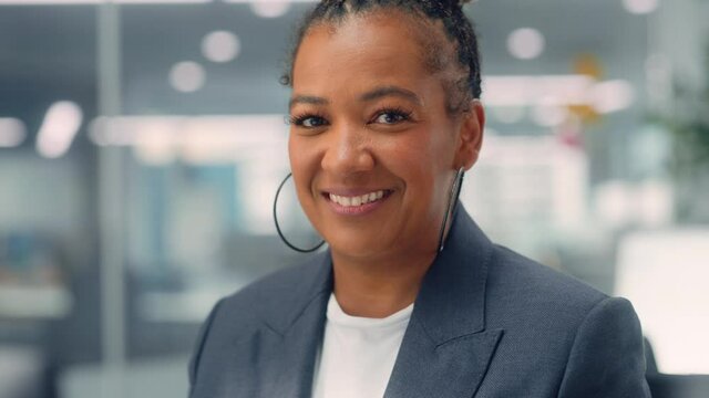 Portrait of a Confident Happy Adult Middle Aged African American Female Wearing Dark Jacket, Looking at Camera, Posing and Charmingly Smiling. Successful Black Woman Working in Diverse Company Office.
