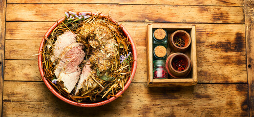 Roast pork in hay with herbs,top view