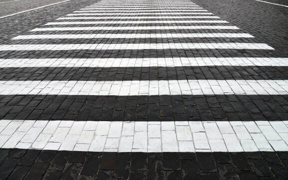 Old cobblestone pavement closeup and white line. © Vlad Ivantcov
