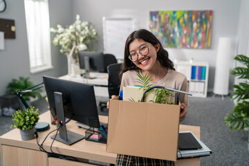 Pretty women with Korean Asian beauty gets a promotion in the office, changes position, carries her things packed in a box, moves them, leave job, she is happy smiling, leaves the company