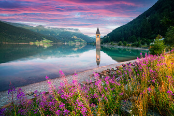 Beautiful view of the lake Resia. Famous tower in the water. Alps, Italy, Europe. Landscape...
