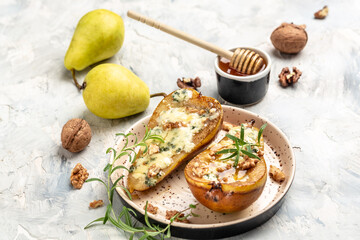 Pears baked with blue cheese, nuts, honey. Food recipe background. Close up