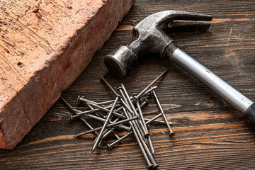 hammer and nails on wooden desk, vintage labor tools on wooden table