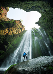 Man in the cave near the Gljufrabui waterfall