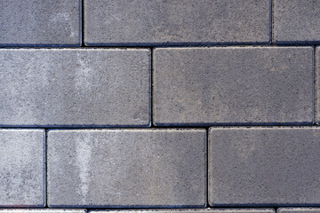 Vibro-pressed concrete paving slabs. Pattern of rectangles, bricks. Texture of road tiles