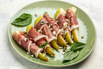 Pear appetizer with jamon, prosciutto ham and blue cheese. Italian antipasto. top view