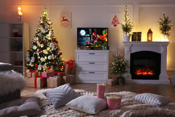 Stylish living room interior with TV set, Christmas tree and fireplace