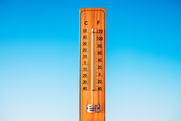 Thermometer and blue sky. The heat. Hot summer day.