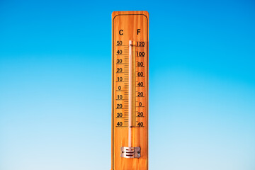 Thermometer and blue sky. The heat. Hot summer day.