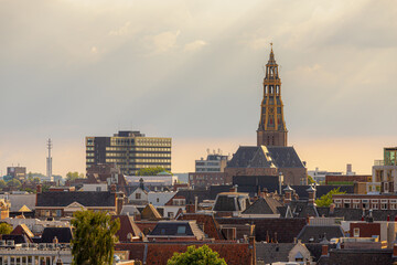 Overview of cityscape with architecture features traditional houses and church in evening, A city in the northern Netherlands, The capital city and main municipality of Groningen province in Holland.