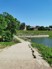 Top view of a wide stone staircase and a dock pool in the Summer Garden of the city of Kronstadt against the background of a cloudless sky