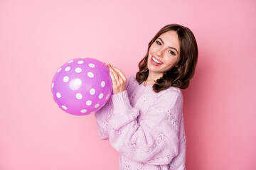 Profile side view portrait of pretty cheerful wavy-haired girl blowing air ball preparing festive isolated over pink pastel color background