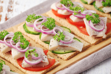 Sandwiches with herring and vegetables