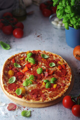 Pizza with salami and basil