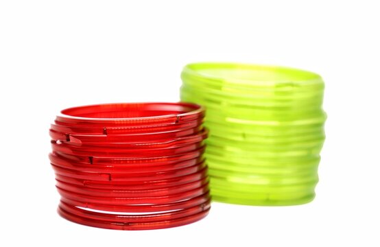 Lime green and red glass bangles isolated on white background