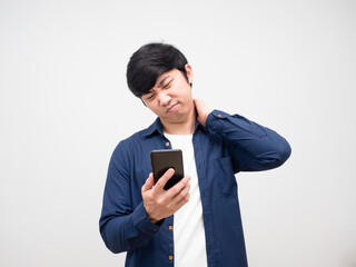 Young man looking at mobile phone in hand and feeling pain his neck