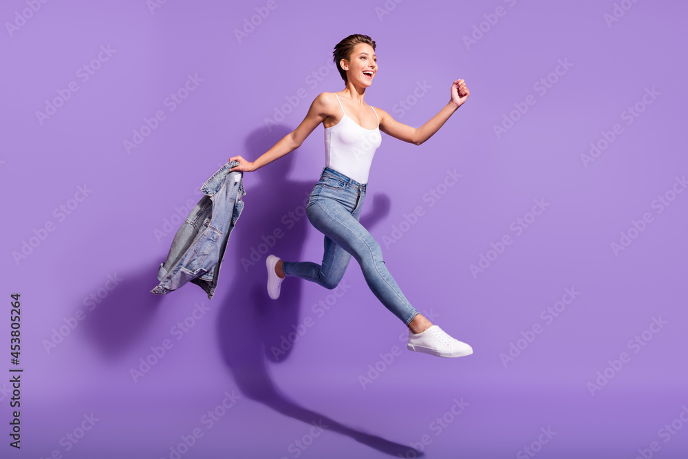 Sticker Full body photo of young cheerful positive woman jump up empty space sale isolated on violet color background