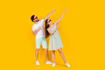 Photo of tourist promoter couple direct finger empty space wear casual outfit isolated yellow color background