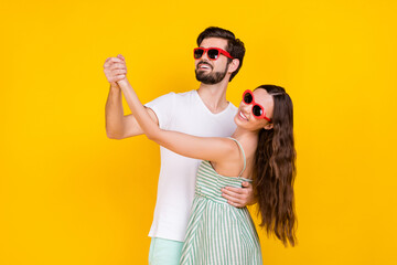 Photo of tourist couple hold hands dance enjoy party vacation wear casual outfit isolated yellow color background