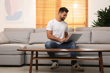 Man using laptop for online shopping at home