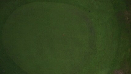 Amazing Aerial Drone shot above red flag putt on green golf course ready for a hole in one