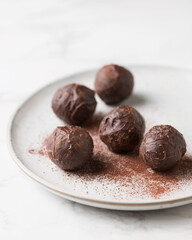 Chocolate candies. Delicious dessert on a light background. Dark chocolate truffles. Sweets on a...