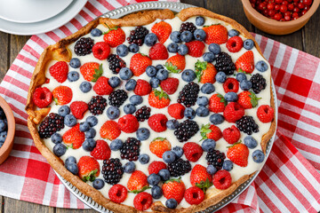 Whole Tart With Fresh Berries And Cream On Napkin, Wooden Background. Flat Lay.